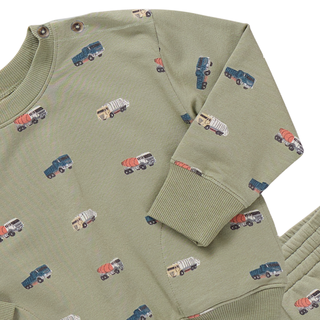 Green sweater with small truck patterns on a white background