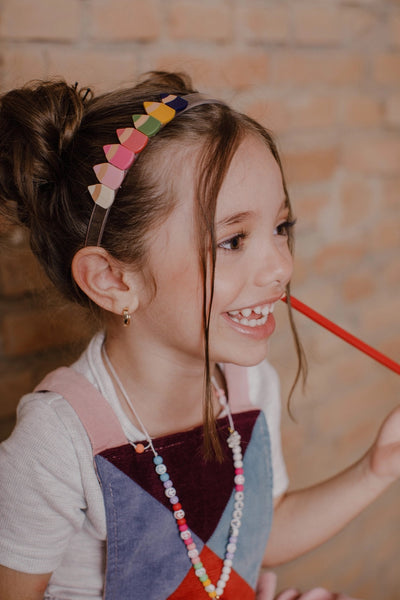 Girl wearing Lilies and Roses NY Multi Colored Pencils Acrylic Headband