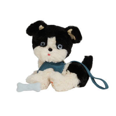 stuffed dog that comes with a leash that is blue and a bone that sticks to his mouth with a magnet. the dog is black and white in color