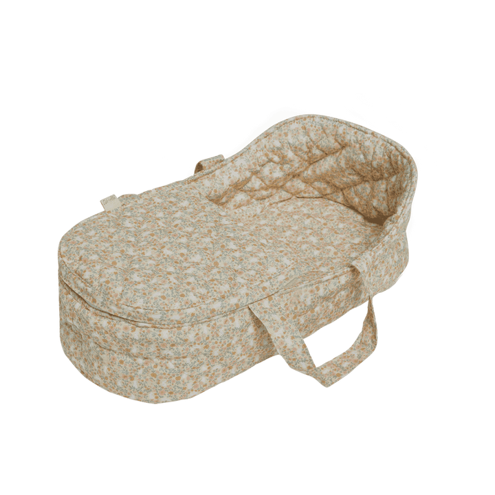 beige floral carry cot with handles 