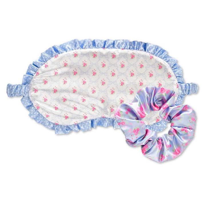 eye mask with white floral print on the opposite side of the mask and matching blue floral scrunchie. 