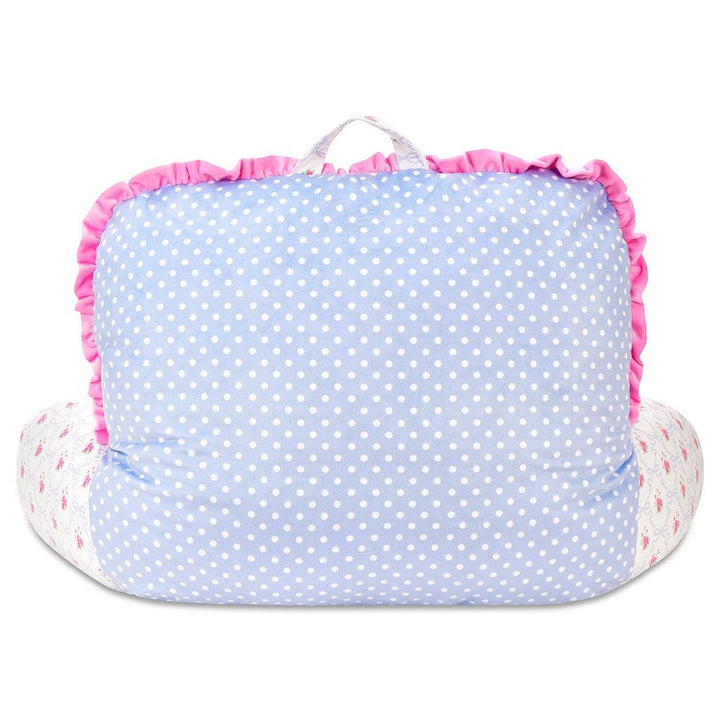 back of lounge pillow where the back of the pillow is polka dots and the front is blue floral pattern. 