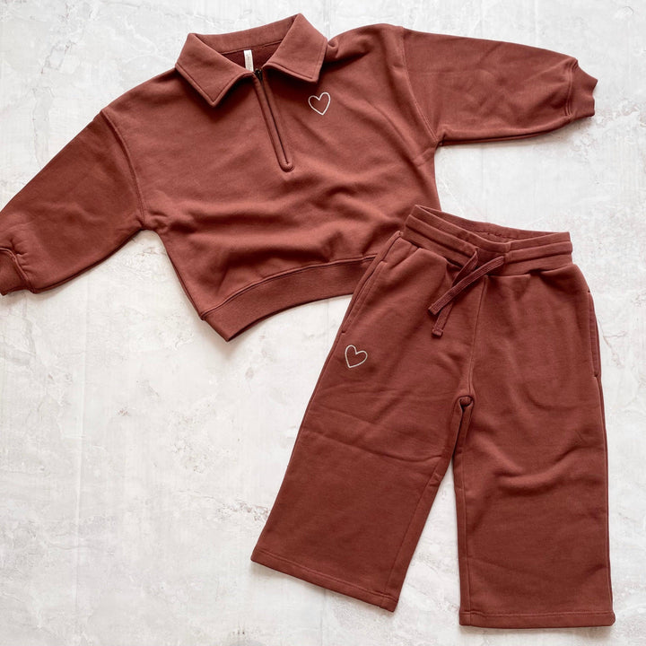 girls sweatsuit in a burgundy color with 3/4 zipper and collar