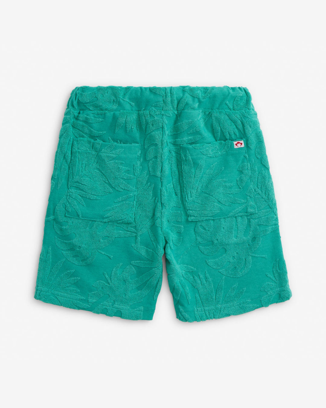 Green shorts with a small logo on a light gray background