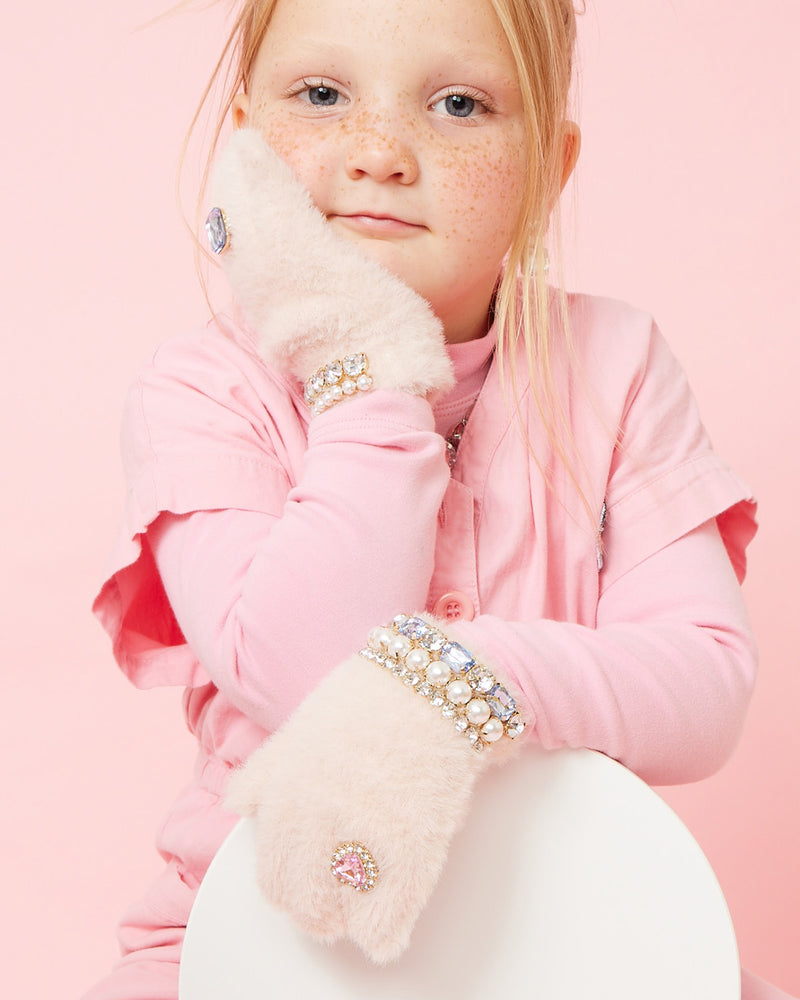 Little girl modeling the pink gloves with rhinestones and pearls. 