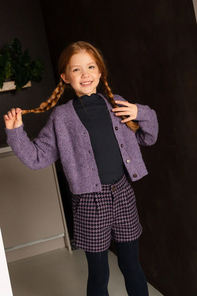 Girl wearing the Like Flo Lavender Deau V-Neck Cardigan with buttons. 