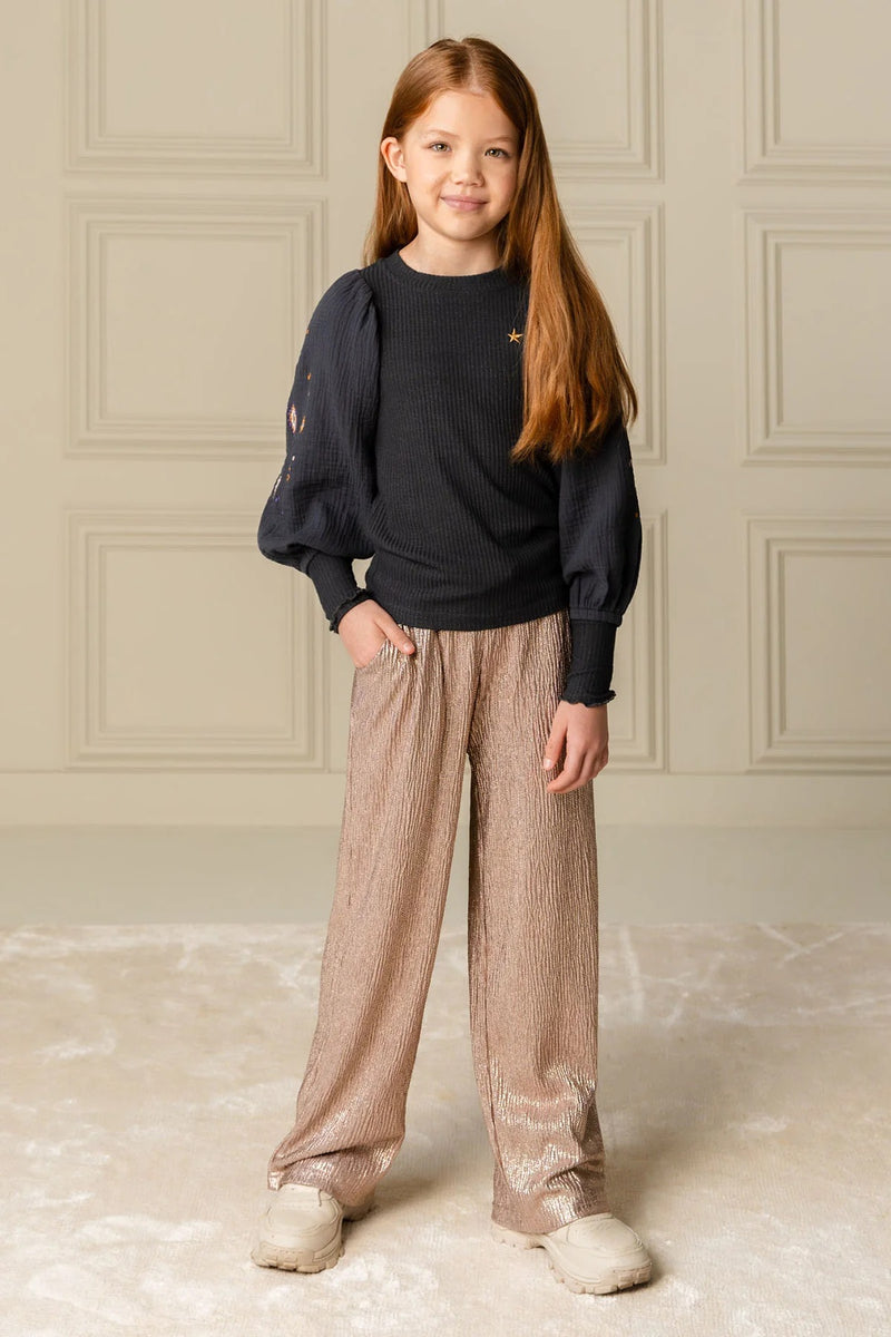 Girl wearing the Fenya Glitter Wide Leg Pant from Like Flo.