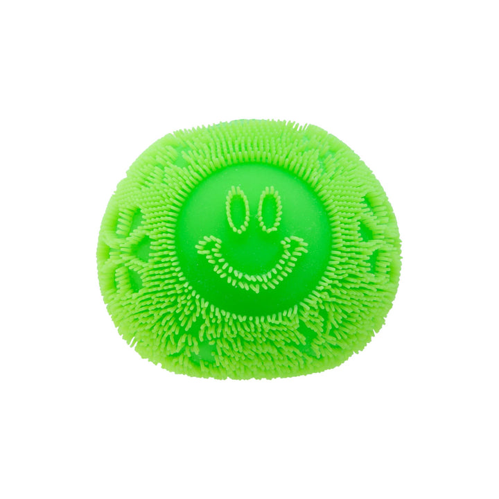 Green toy balls with a smiley face design on a white background