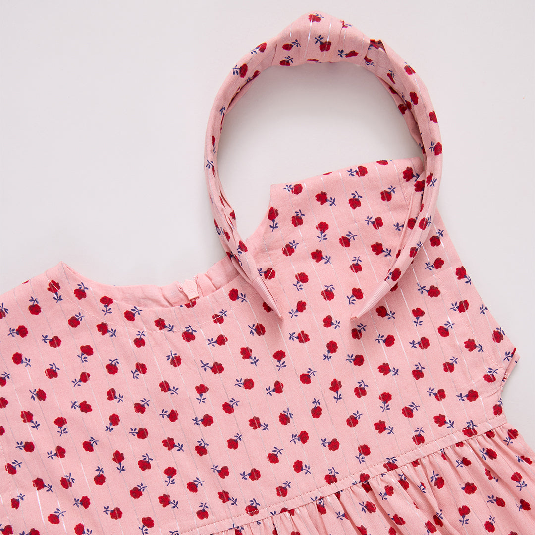 Pink dress with red floral pattern and matching headband 