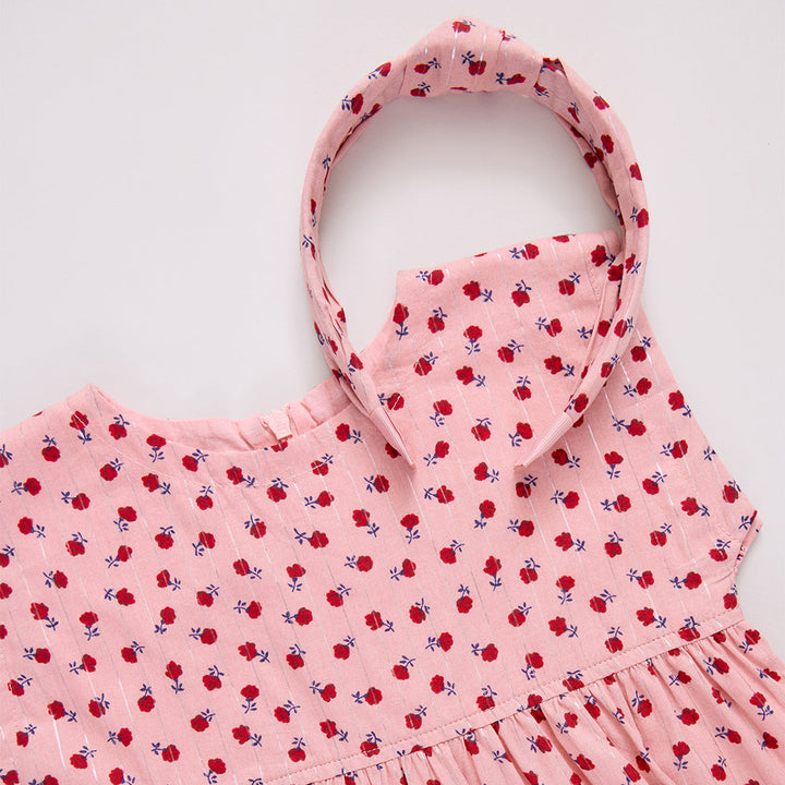 Pink dress with red floral pattern and matching headband 