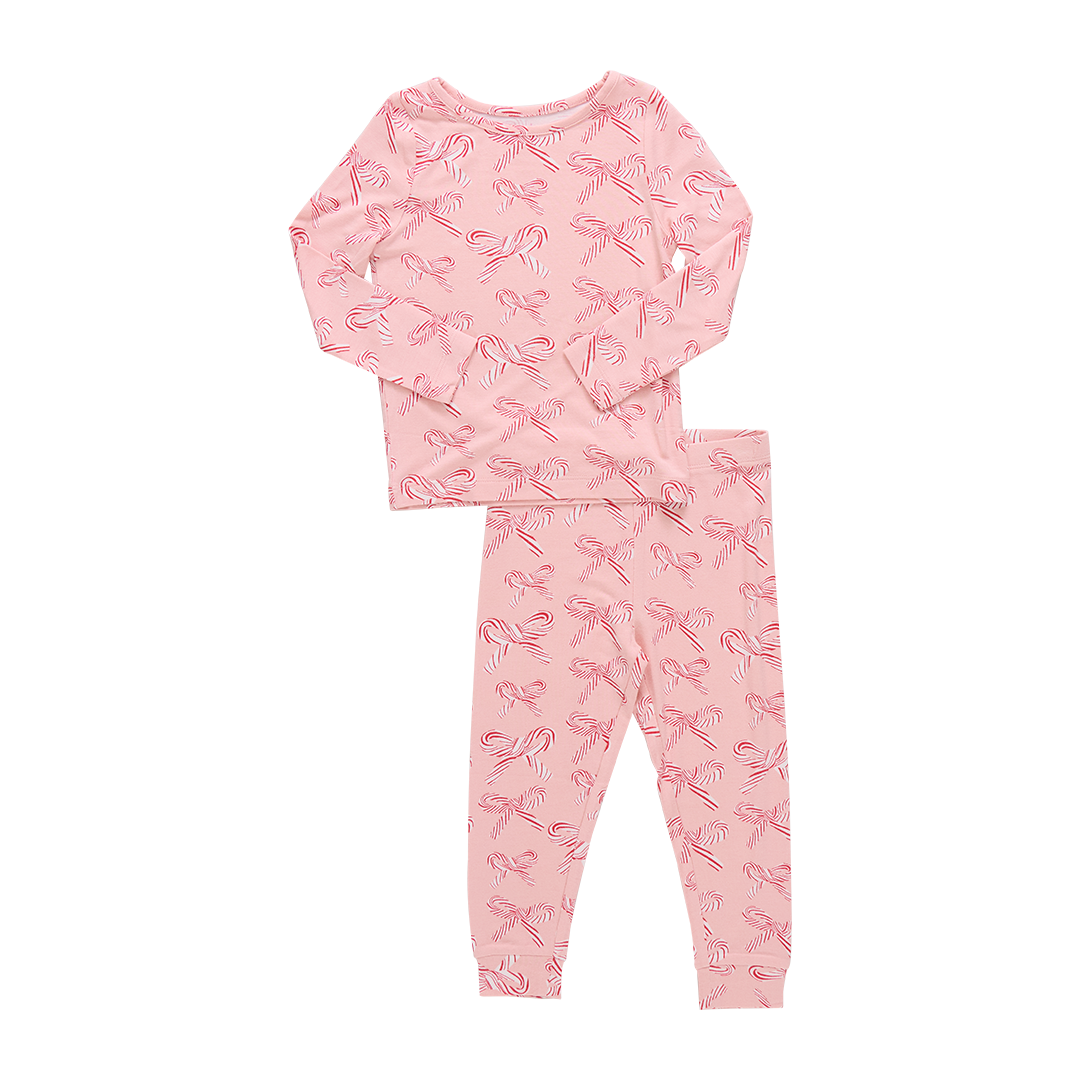 Pink pajama set with candy cane  bow pattern on a white background