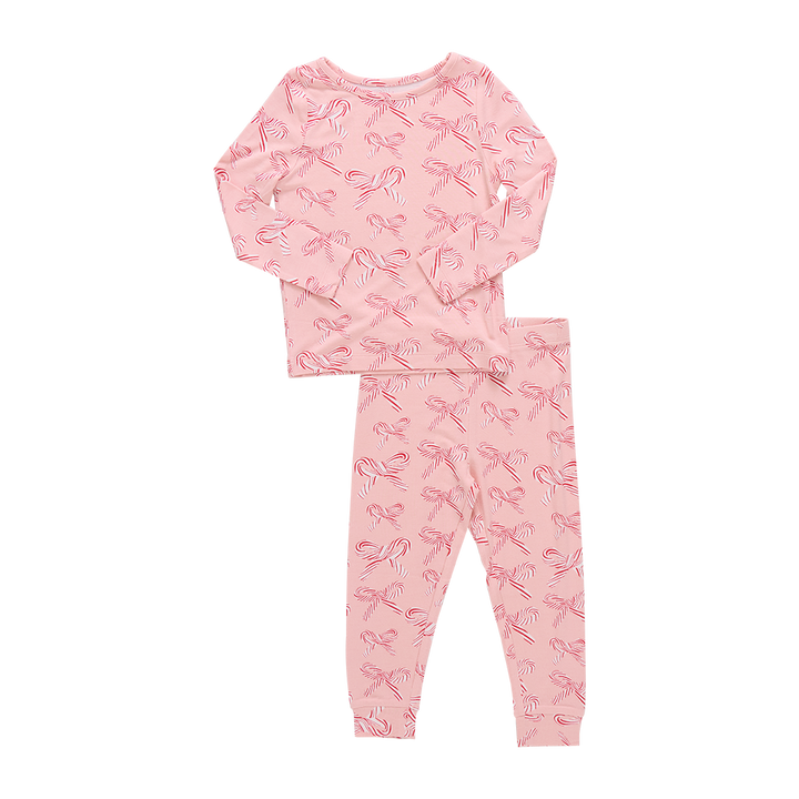 Pink pajama set with candy cane  bow pattern on a white background