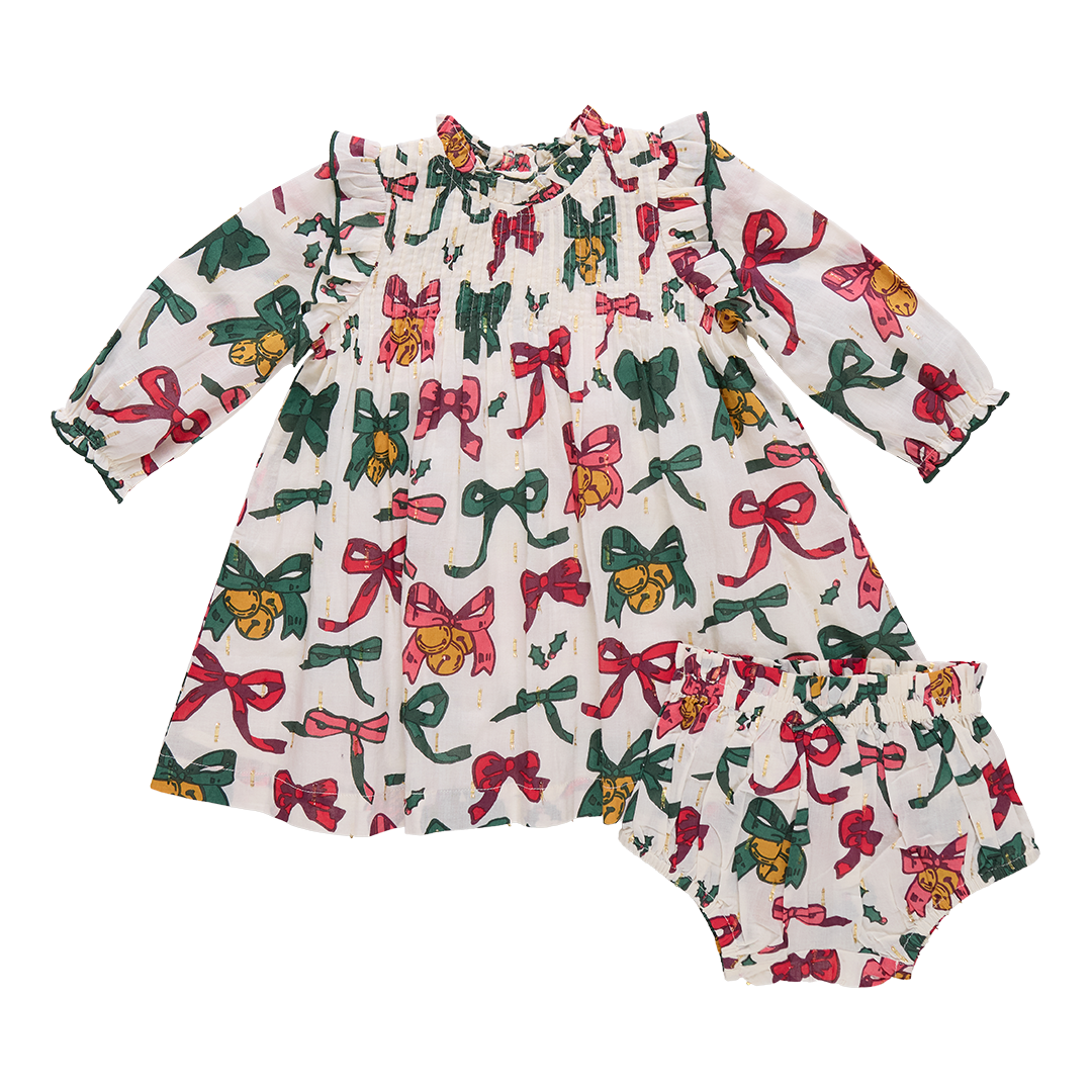 Children's dress with colorful bow pattern on a white background