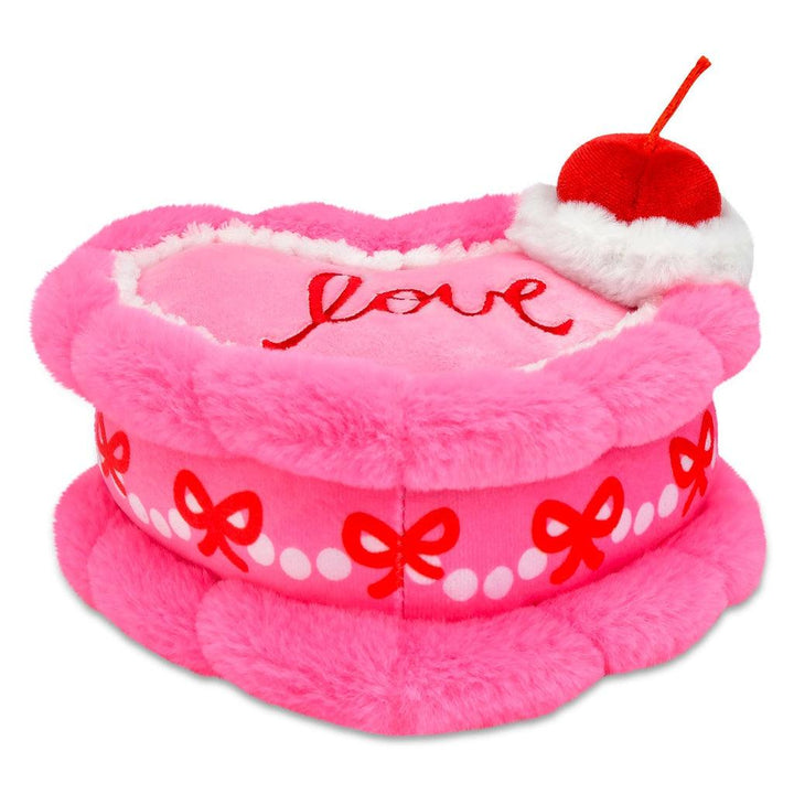 heart plush cake view from the side. hot pink cake with bows all along the side of the cake 