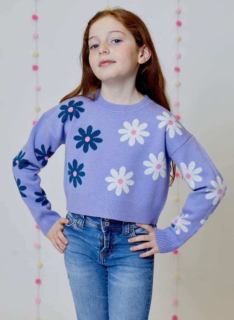 Girl is wearing Design History Lilac Combo Crew Neck sweater with daisy print.