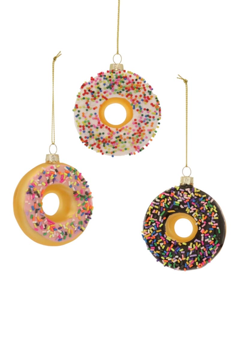 glass holiday ornaments shaped like donuts with icing and sprinkles on them. 