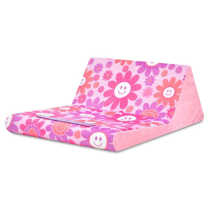 this picture shows the big bold daisies and smiley faces all over the tablet pillow as it is fully extended. 