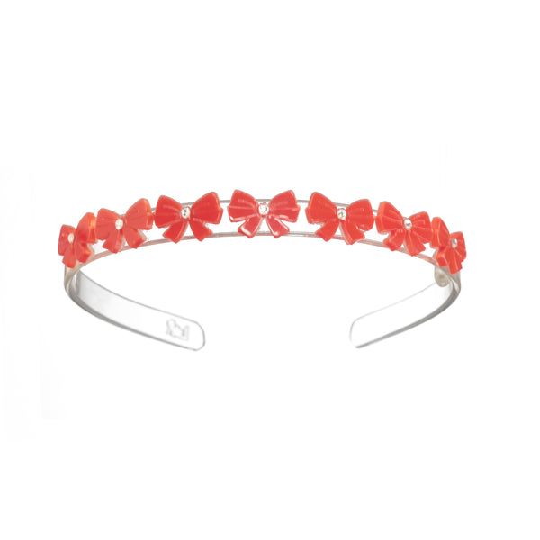 acrylic headband with red bows lined up along the top of the headband