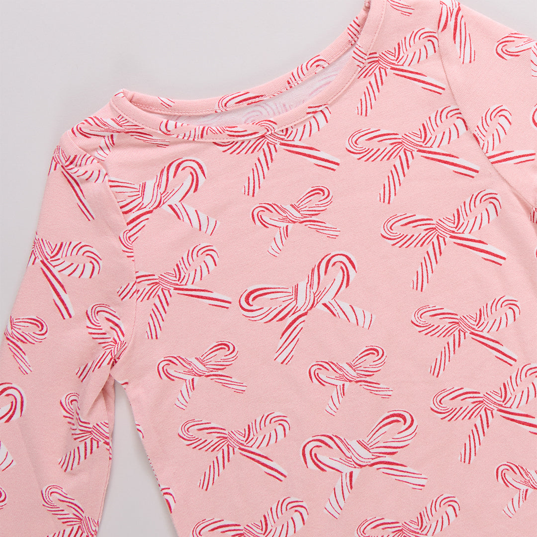 Pink long-sleeve shirt with candy cane pattern on a light gray background
