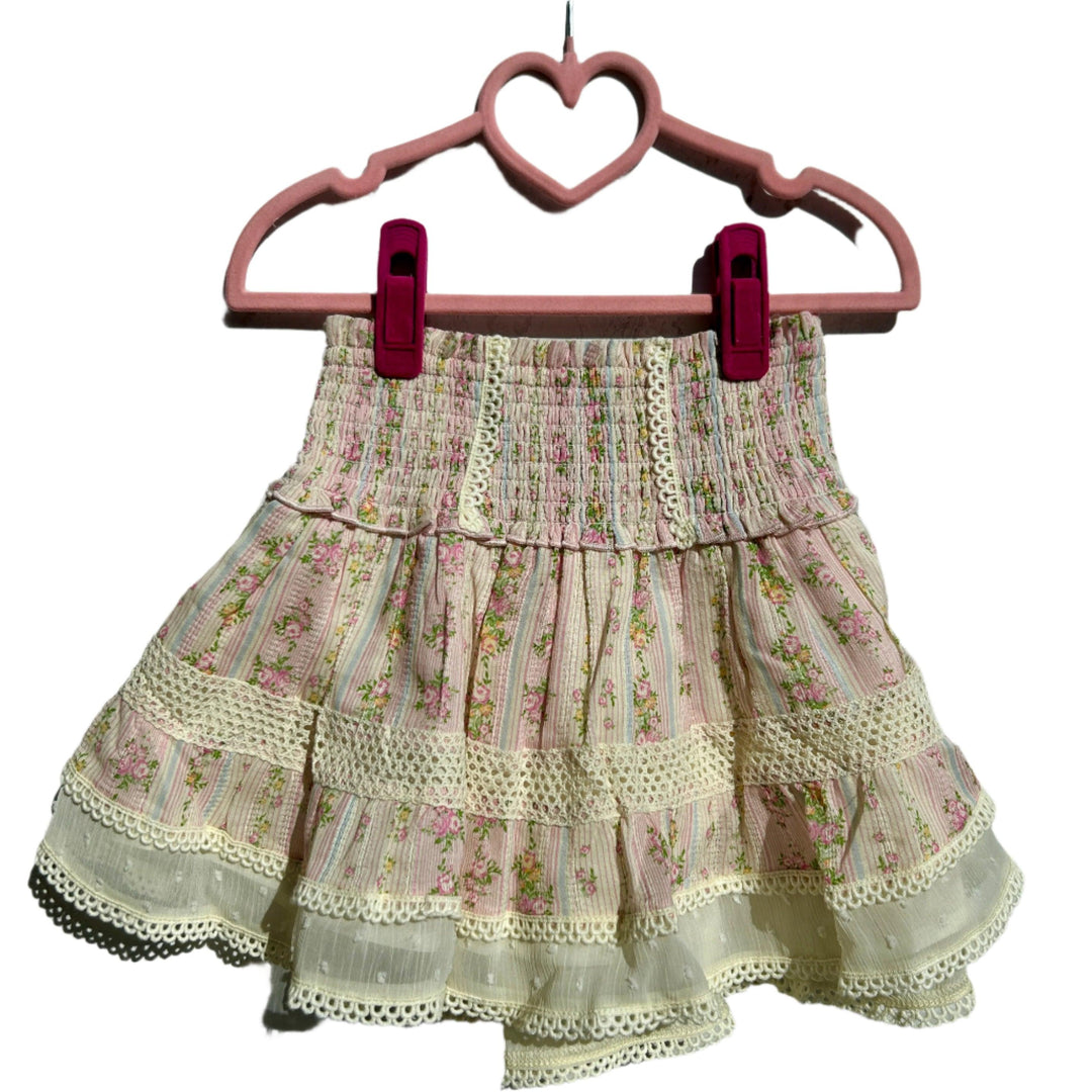 shabby floral stripe skirt with beige lace trim along the bottom and throughout the skirt. the skirt is mostly pink with floral stripes going down the center. 