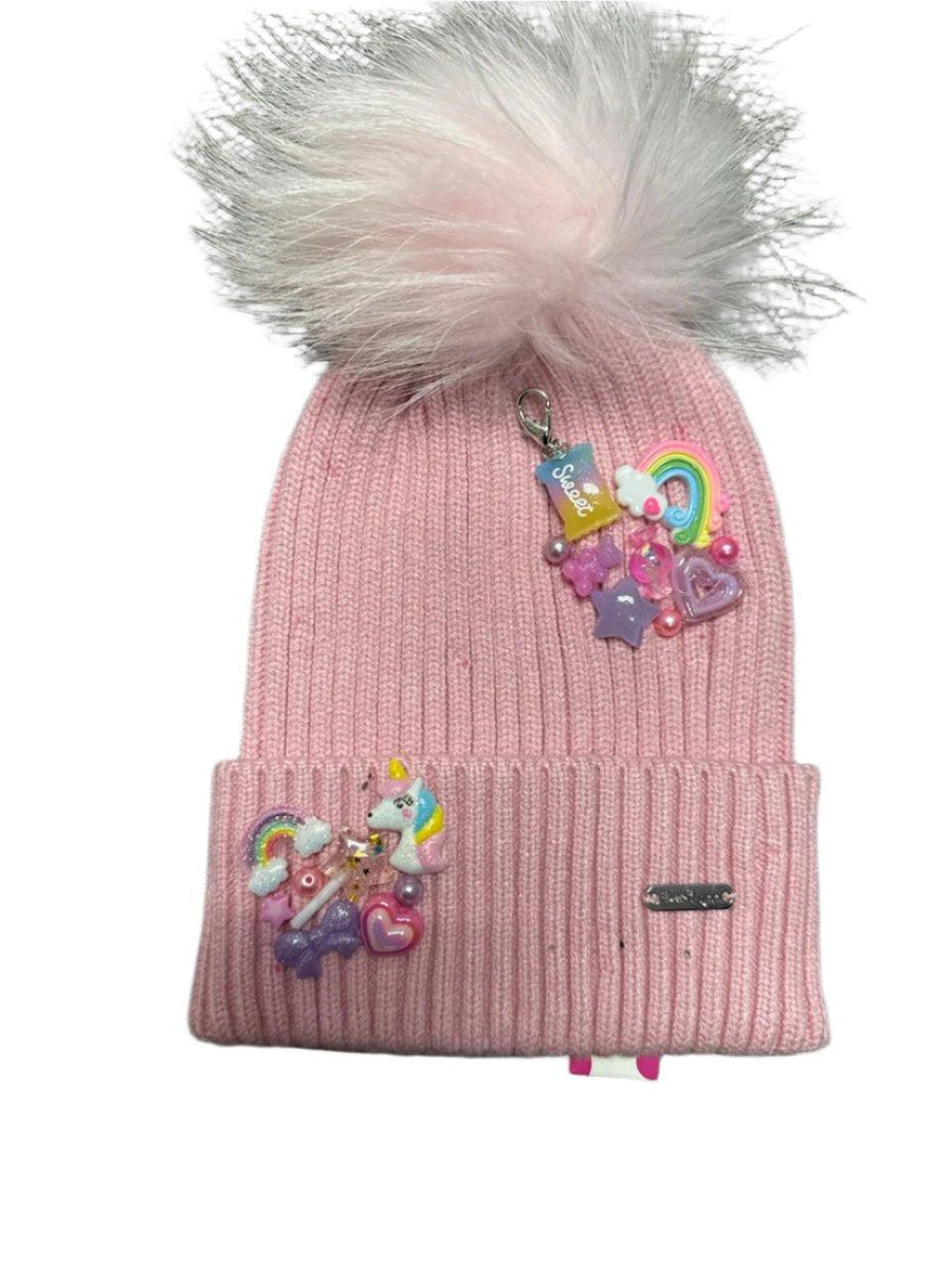 pink beanie hat with pom pom. girly charms sewn onto hat with foldover cuff. 