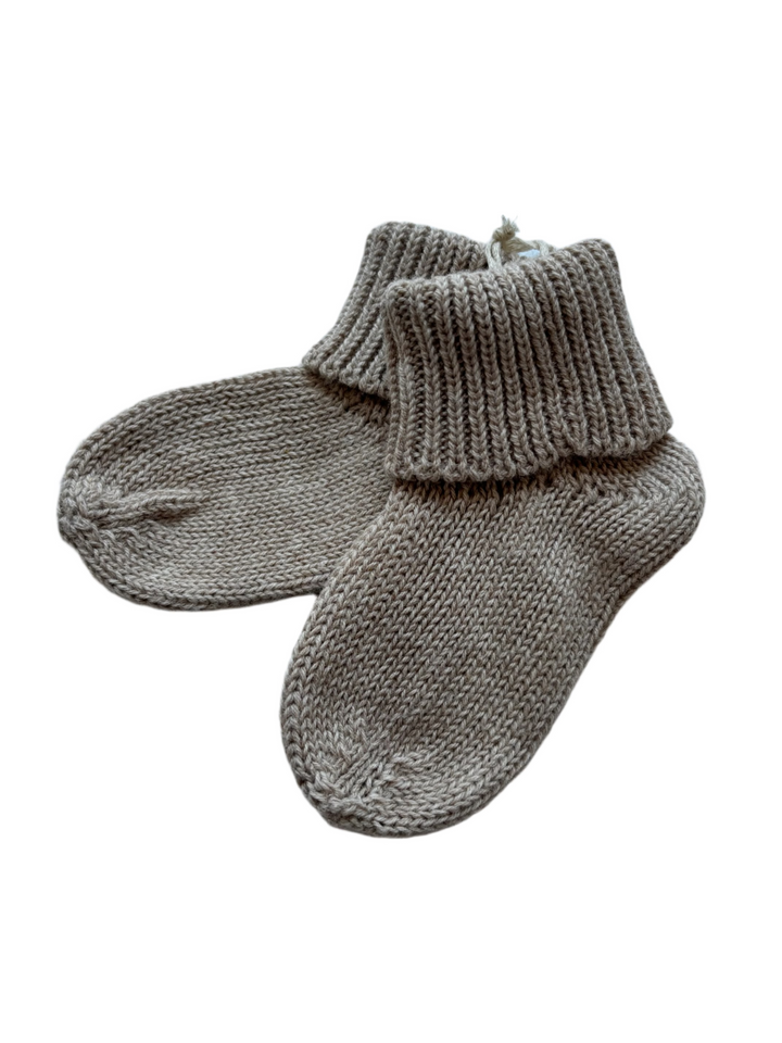 Pair of beige knitted baby socks
