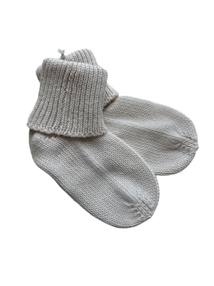 Pair of beige baby knitted socks 