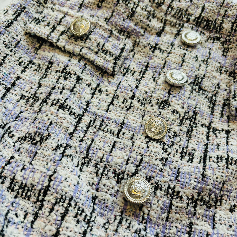 Close up picture of the silver button detailing and tweed details of skirt by Flowers by Zoe