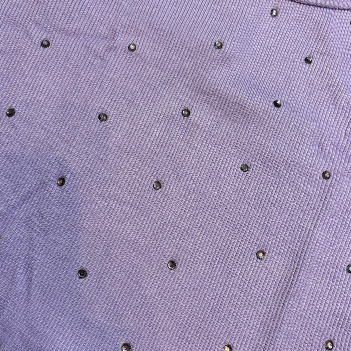 Picture features the stud detailing on the light purple top from Flowers by Zoe