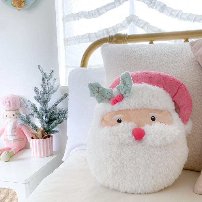 This picture shows the santa pillow sitting on the bed adding christmas cheer to the bed !