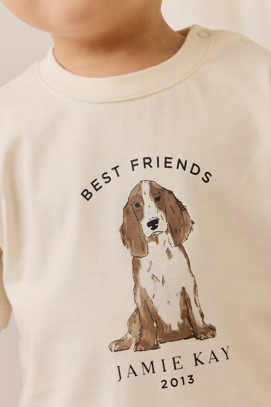 Children's shirt with a dog illustration and 'Best Friends' text on a plain background