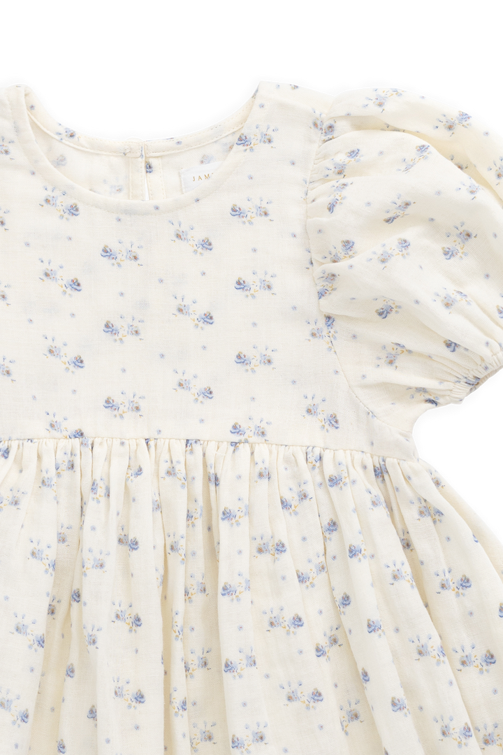 Close-up of a white dress with blue floral pattern