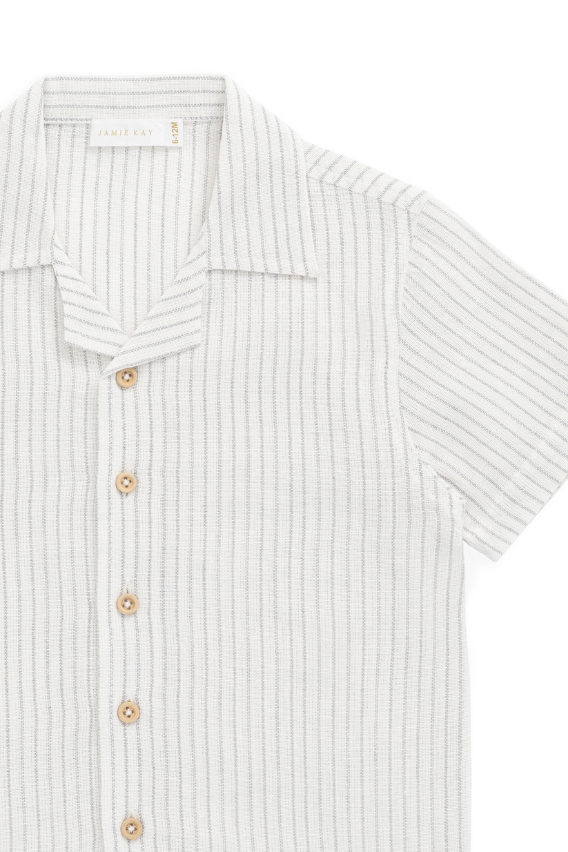 Close-up of a striped shirt with buttons on a white background