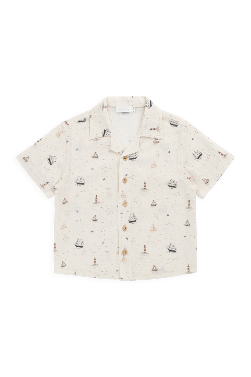 Short-sleeve shirt with ship pattern on a white background
