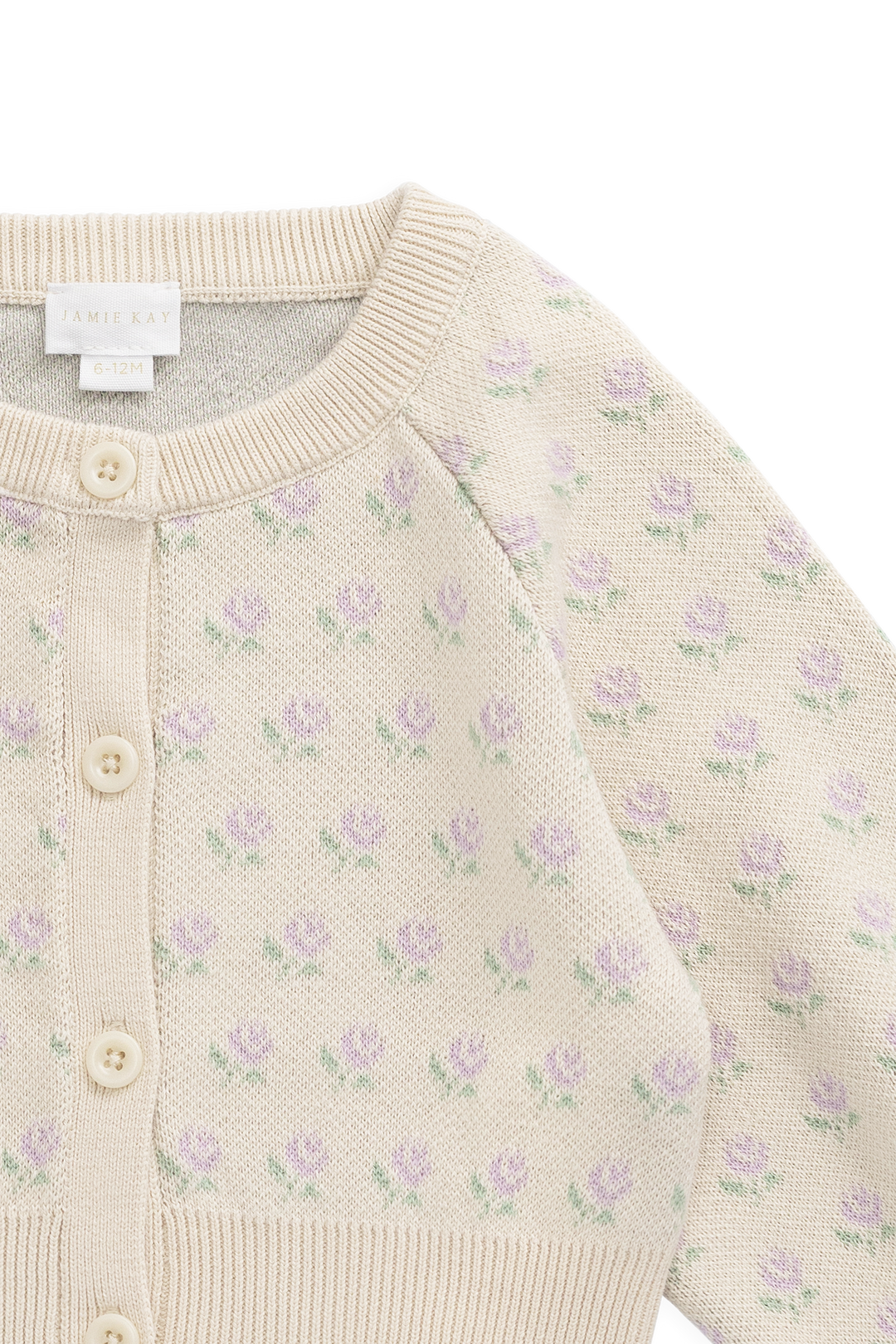 Beige cardigan with purple floral pattern on a white background