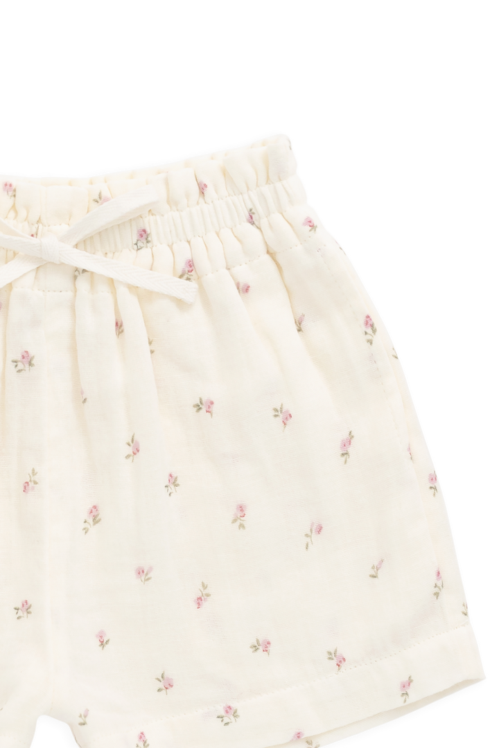 White shorts with subtle floral pattern on a white background