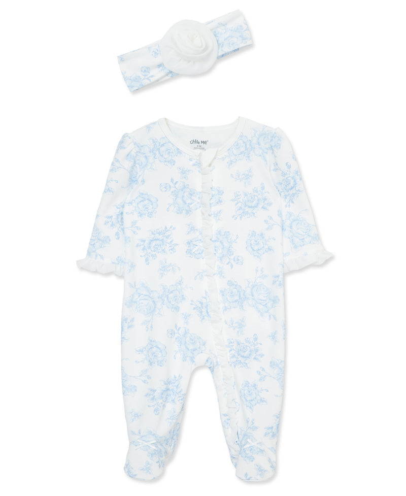 Baby onesie with blue floral pattern and matching headband on a white background