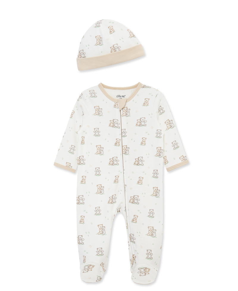 Baby onesie and hat set with teddy bear pattern on a white background