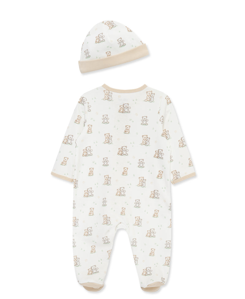 Baby onesie and hat set with teddy bear pattern on a white background