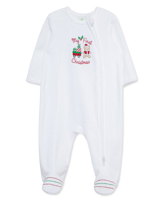 white velour baby footie that says "My First Christmas" on the chest. 