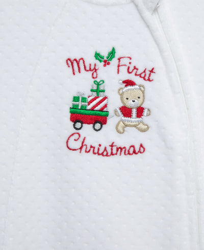 baby footie made of white velour with "my first christmas" written on the chest complete with teddy bear and christmas wagon