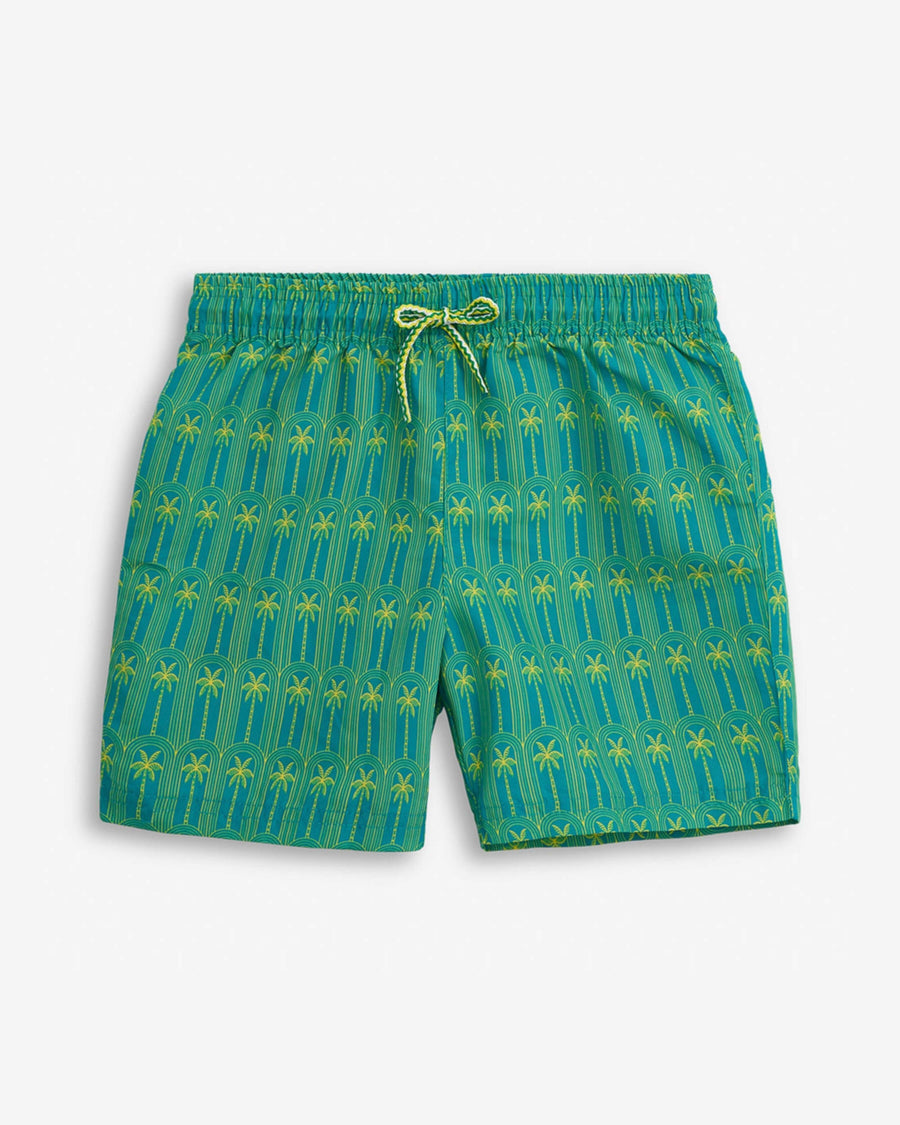 Green patterned swim shorts on a white background