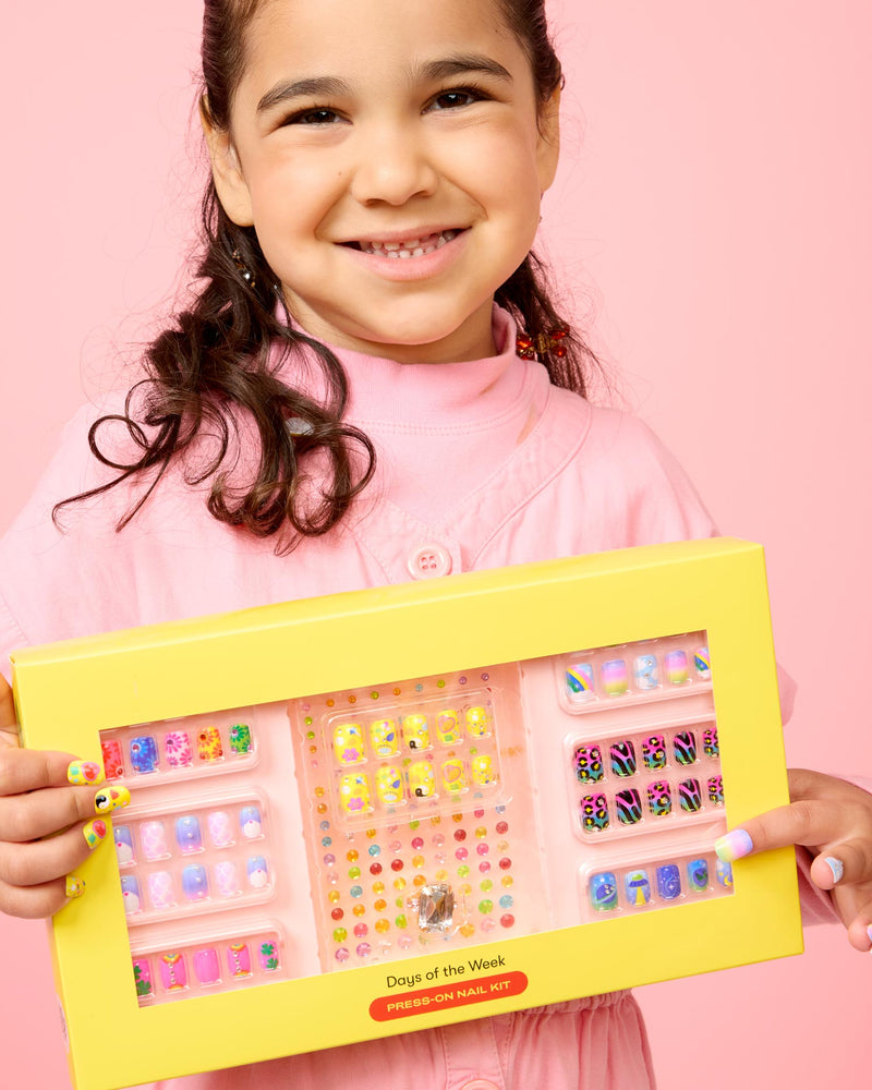 girl holding the nail kit in the cute yellow packaging