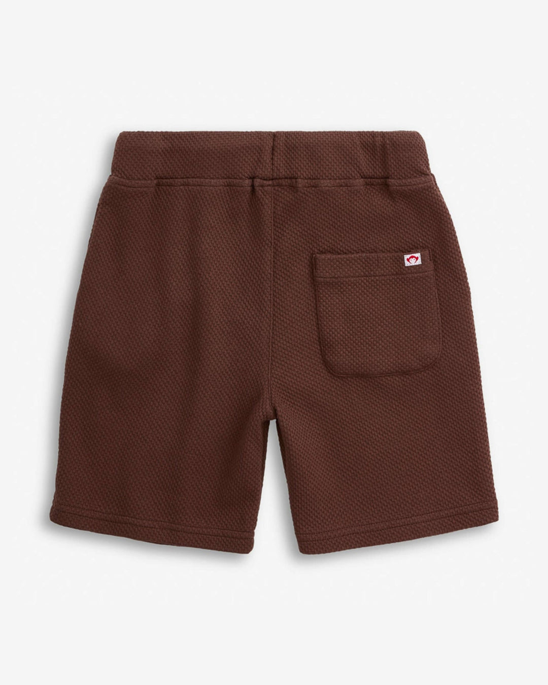 Brown shorts with a pocket on a light gray background