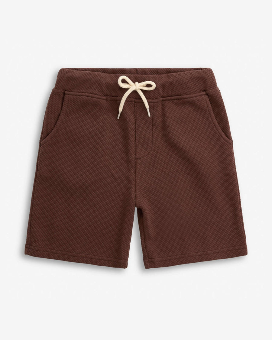 Brown shorts with a white drawstring on a light gray background