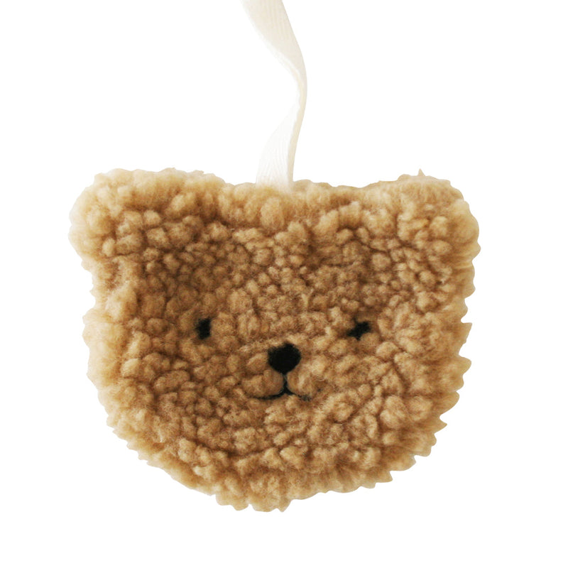 sherpa bear in caramel color attached to a string that will hold a pacifier