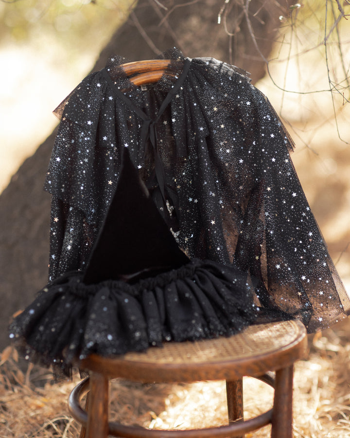 lack tulle cape with silver stars and tie at the neck. 