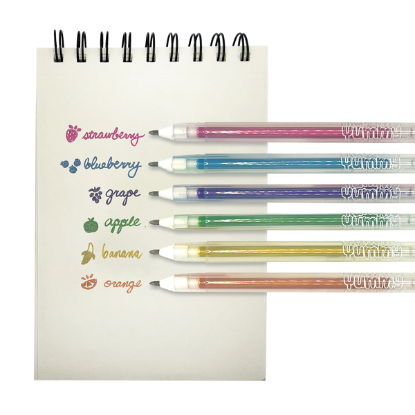 Set of colorful pens with fruit-themed labels on a notebook