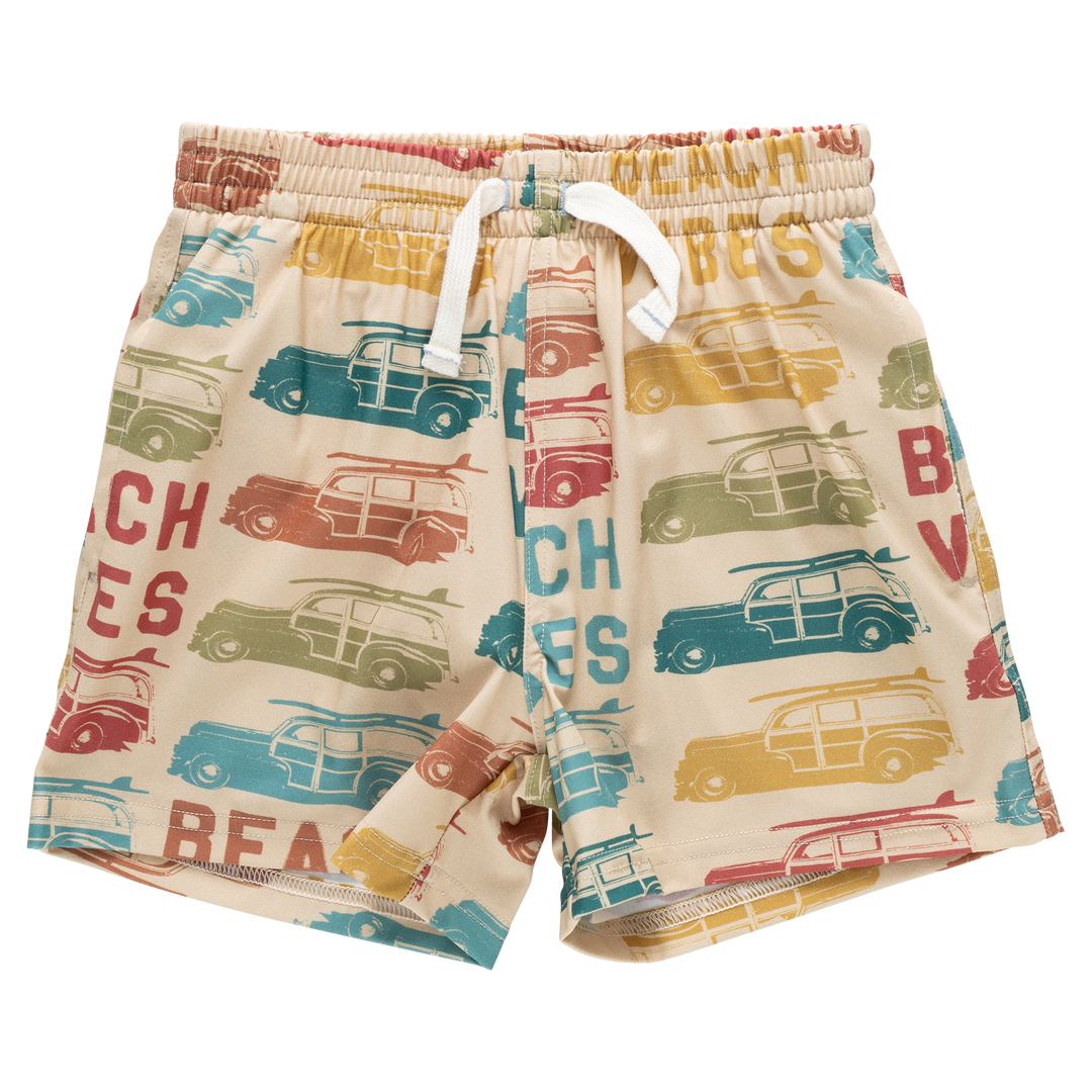 Beige shorts with vintage car and beach-themed print on a white background