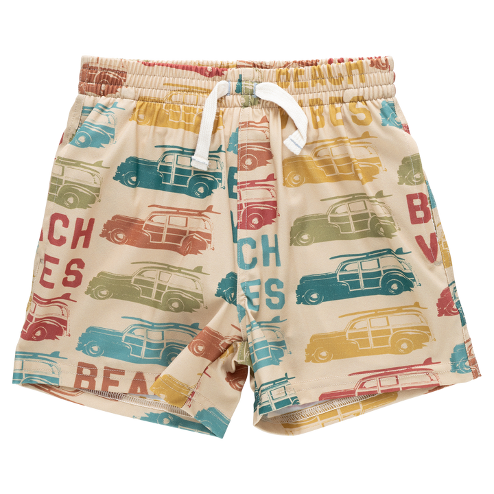 Beige shorts with vintage car and beach-themed print on a white background